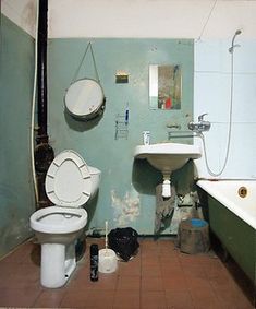 a bathroom with a toilet, sink and bathtub in it's center area