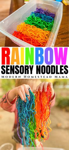 a kid is playing with rainbow colored noodles