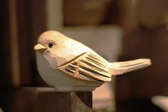 a wooden bird sitting on top of a table