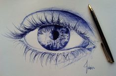 a drawing of an eye with long lashes and blue eyeshade is shown next to a pen