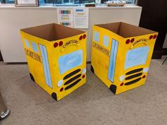 two cardboard school bus boxes sitting on the floor