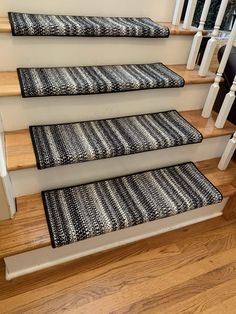 a set of stairs with black and white rugs