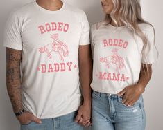 "Looking for the perfect shirt to match your child's first rodeo birthday shirt? Look no further than this \"Rodeo Mama\" and \"Rodeo Daddy\" t-shirt! This comfortable and stylish t-shirt is perfect for any mom who loves the rodeo and wants to show off her support for their cowgirl. Whether you're cheering them on from the stands or helping them get ready for the big event, this shirt is sure to become a go-to in your wardrobe. Details * * * * * * * * * * * * * * * * * * * * * * * * * * * 🖤 100 Rodeo Mama Shirt, First Rodeo Outfit Girl, White Letter Print Top For Rodeo, First Rodeo Outfit, 1st Rodeo Birthday Party Girl, My First Rodeo Birthday Girl, Cowgirl First Birthday Party, First Rodeo Birthday Party Girl, Rodeo Mom