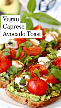 an avocado toast is topped with tomatoes and spinach on a white plate