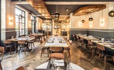 an empty restaurant with wooden tables and chairs