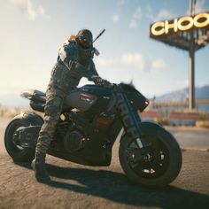 a man riding on the back of a motorcycle in front of a sign that reads choo