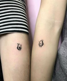 two people with matching tattoos on their arms, one has an eye and the other has a nose