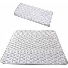 the mattress pad and pillow are both made out of white quilted material, with one side folded open