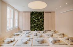 a large room with many pieces of white material on the floor and in front of a green wall