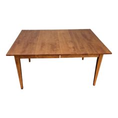 a wooden table with two leaves on the top and one leaf at the bottom, against a white background