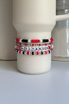 Personalized collection of Red and Black beaded bracelets hand crafted to add personal style to your Stanley cup.  🌟 Great for gift giving, holidays, sports, parties, and everyday charm. 🌟 Set includes 4 bracelets designed to fit the 40oz Stanley Quencher with a silicone boot in place.  🌟 Add your own Personalization to this set. Letters, Numbers, and Hearts only. Recommend 10 characters or less for visibility. Spaces will be filled with a small, silver, circular bead.  🌟 Message me if you would like to create a similar set with different colors.  Tips & Care: - Will also fit the 20oz and 30oz Stanley cups with a silicone boot (not included) - Remove bracelets prior to washing tumbler. Not dishwasher safe. - Given the nature of elastic, stretching or breakage may occur overtime. Take c Black Beaded Bracelets With Letter Beads For Valentine's Day, Black Beaded Bracelet With Letter Beads For Valentine's Day, Casual Red Friendship Bracelets With Round Beads, Casual Black Beaded Bracelets For Valentine's Day, Casual Red Round Beads Friendship Bracelets, Casual Red Round Beads Friendship Bracelet, Customized Red Beaded Bracelets As Gift, Customized Red Beaded Bracelet For Gift, Trendy Personalized Red Friendship Bracelets