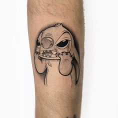 a tattoo on the leg of a man with an image of a dog holding a plate