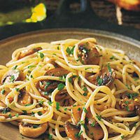 pasta with mushrooms and parsley on a plate