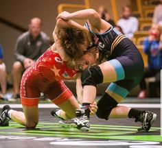 two women wrestle in a wrestling match