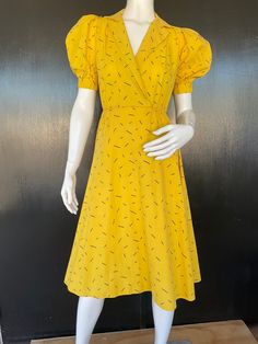 "1980s Lucky Barbara pullover dress. Yellow and black cotton/polyester blend. Surplice bodice. Puff sleeves with black insert and one button cuffs. Elastic waist. Measurements are  34\" bust 22\" to 26\" waist Free hips 16\" bodice length  43\" length  12\" sleeves 13 1/2\" back shoulders (between sleeve seams) Bright dress shows well exhibiting very minimal to no wear." Fitted Cotton Puff Sleeve Dress For Work, Vintage Fitted Midi Dress With Gathered Sleeves, Chic Yellow Puff Sleeve Midi Dress, Yellow Fitted Lined Midi Dress, Yellow Lined Fitted Midi Dress, Spring Retro Puff Sleeve Dress, Yellow Fitted Dress With Gathered Sleeves, Fitted Yellow Dress With Gathered Sleeves, Yellow Fitted Midi Dress, Lined