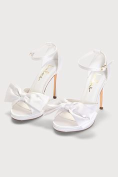 Treat yourself to an extra sweet look with the Lulus Lanely White Satin Bow High Heel Sandals! Sleek woven satin shapes these cute heels that have a peep-toe upper with a wide toe strap adorned with a decorative bow accent. An adjustable ankle strap with a shiny gold buckle tops a chic stiletto heel. 4. 25" wrapped stiletto heel. Cushioned insole. Felted rubber sole has nonskid markings. Man Made Materials. Imported. Lulus | Lanely White Satin Bow High Heel Sandal Heels | Size 11. Satin Heels White, White Heels With Bow, White Bow Heels, Heels With Bows, Ribbon Heels, White Heels Wedding, White High Heels, Elegant Heels