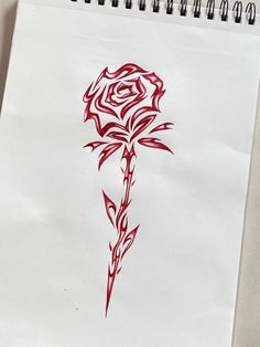 a drawing of a red rose on white paper