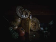 a bunch of fruit sitting on top of a table next to other fruits and vegetables