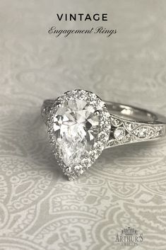 an engagement ring with a pear shaped diamond in the center