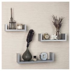 three white shelves with decorative items on them