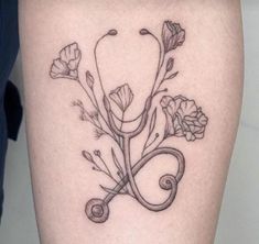 a black and white photo of flowers on the thigh