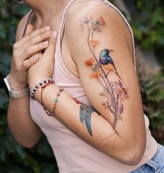 a woman with tattoos on her arm and chest