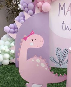 a pink dinosaur birthday party with balloons and decorations