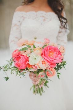 a bride holding a bouquet of flowers in her hands