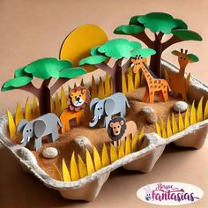 an egg carton filled with animals and trees