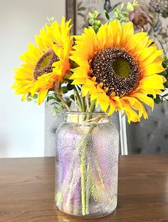 sunflowers are arranged in a vase on a table