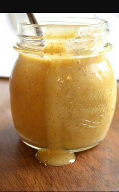 a jar filled with liquid sitting on top of a wooden table