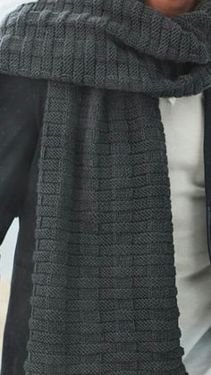 a woman is wearing a scarf and jacket