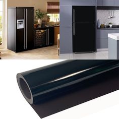 a kitchen with refrigerator, cabinets and a large roll of black vinyl