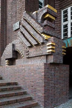 a brick building with stairs leading up to the top floor and bottom part of the building