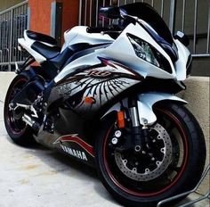 a white and black motorcycle parked next to a building