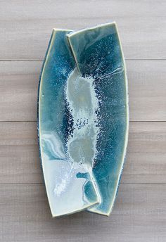 a blue and white plate on top of a wooden table