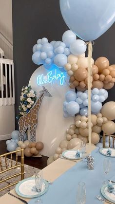 a giraffe balloon decoration is on display at a baby shower