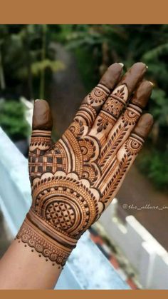 a person's hand with henna tattoos on it