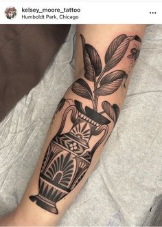 a black and white tattoo on the arm of a person with a vase in it