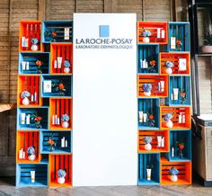 an orange and blue book shelf filled with lots of books