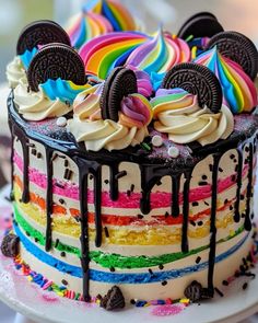 a cake decorated with oreo cookies and rainbow icing