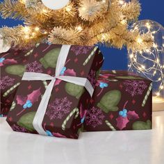 two wrapped presents under a decorated christmas tree