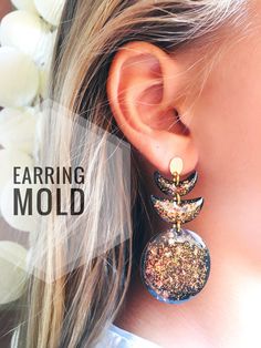 the earring mold is designed to look like a bird and has glitter on it