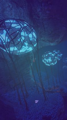 two circular lights in the middle of a blue underwater cave filled with rocks and plants