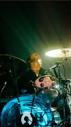 a man playing drums on stage at a concert