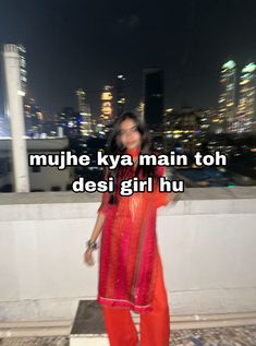 a woman standing on top of a roof with the words mujhe ky main toh desi girl hu