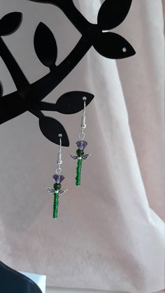 These thistle earrings is in a silver tone. Purple and green crystals. Green seed beads. Green Beaded Pierced Earrings, Nickel-free Green Metal Beaded Earrings, Adjustable Nickel Free Green Crystal Earrings, Handmade Green Crystal Sterling Silver Earrings, Green Beaded Earrings With Silver Beads As Gift, Thistle Earrings, Crystals Green, Pewter Earrings, Scottish Thistle