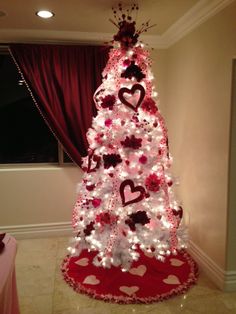 a decorated christmas tree with hearts on it