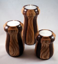 three wooden candles are sitting next to each other