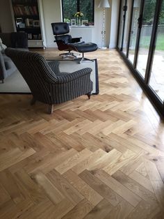 a living room with hard wood flooring and large glass doors leading to the outside